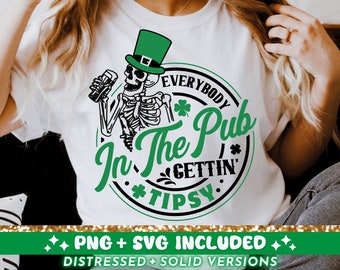 May include: A white t-shirt with a green, black, and white graphic of a skeleton wearing a green leprechaun hat and holding a beer. The graphic says "Everybody In The Pub Gettin' Tipsy".