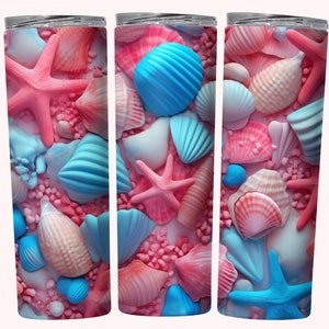 May include: Three stainless steel tumblers with a pink and blue seashell design. The tumblers are filled with pink and blue seashells, starfish, and sand.