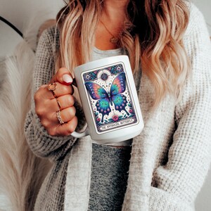 May include: White ceramic mug with a colorful butterfly illustration and the text "The Antisocial Butterfly".