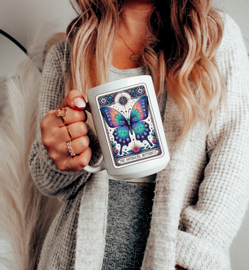 May include: White ceramic mug with a colorful butterfly illustration and the text "The Antisocial Butterfly".