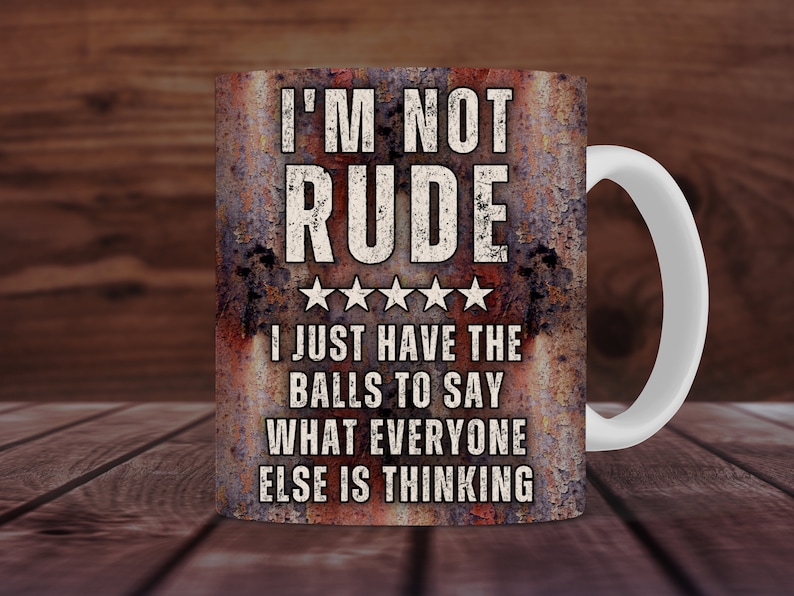 May include: A white ceramic mug with a rusty brown design. The mug features the text "I'M NOT RUDE" with five stars and the text "I JUST HAVE THE BALLS TO SAY WHAT EVERYONE ELSE IS THINKING".