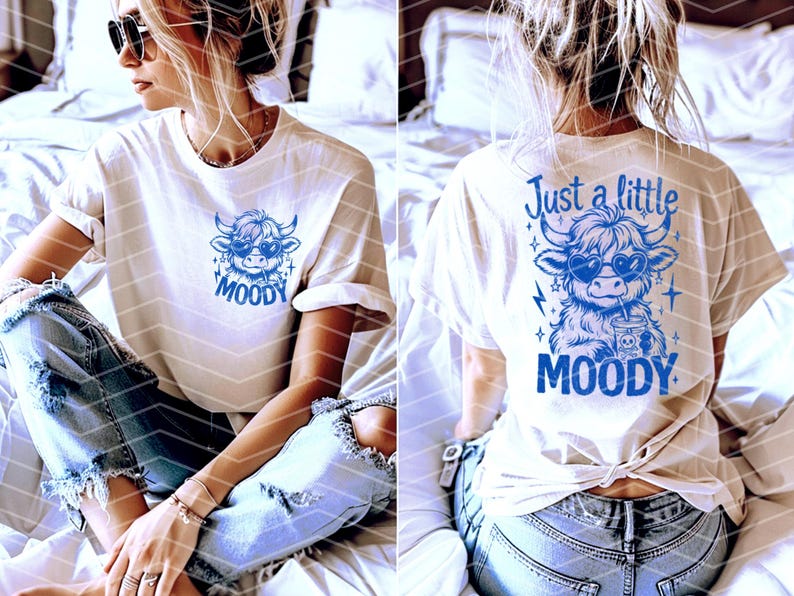May include: White t-shirt with a blue graphic of a cow wearing sunglasses and the text "Just a little moody".