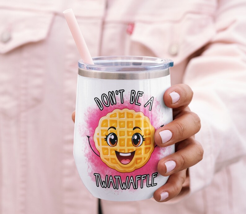 May include: White stainless steel tumbler with a pink, yellow, and brown waffle graphic. The tumbler has the text "Don't be a Twatwaffle" printed on it.