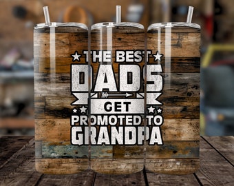 May include: Three stainless steel tumblers with a wood grain design. The tumblers have a white design that says "The Best Dads Get Promoted to Grandpa".
