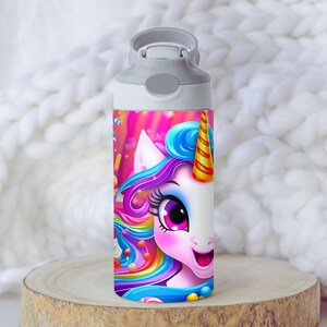 May include: A white water bottle with a gray lid and a colorful unicorn design. The unicorn has a rainbow mane and tail, and is surrounded by candy and other colorful elements.