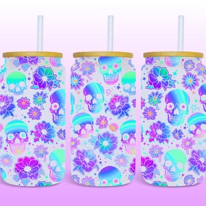 May include: Three white stainless steel tumblers with a holographic skull and flower pattern. Each tumbler has a bamboo lid and a clear plastic straw.