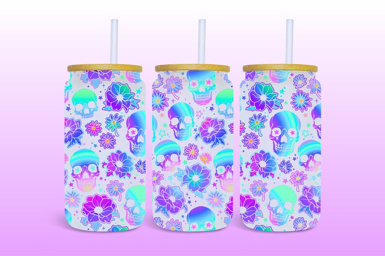 May include: Three white stainless steel tumblers with a holographic skull and flower pattern. Each tumbler has a bamboo lid and a clear plastic straw.