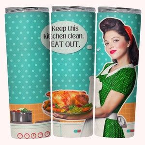 May include: A stainless steel tumbler with a turquoise background and white polka dots. The tumbler features a retro-style illustration of a woman holding a platter of roasted turkey with green peas and carrots. The text on the tumbler reads "Keep this kitchen clean. EAT OUT."