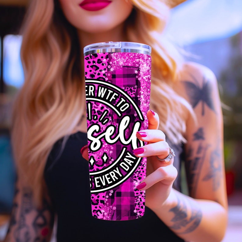 May include: Pink and black tumbler with a glitter finish. The tumbler has a round sticker with the text "Whatever WTF to Yourself Every Day".