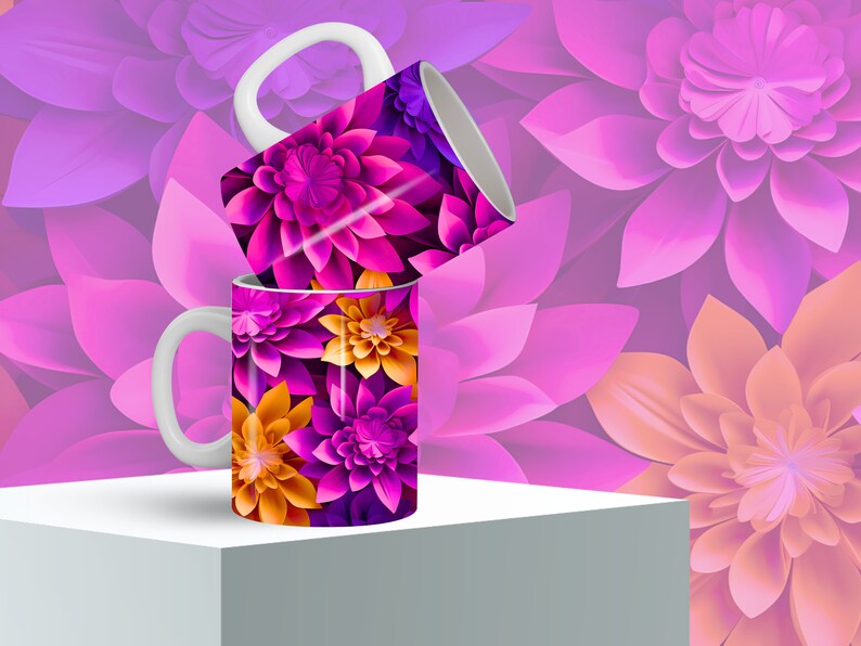 K&ouml;nnte beinhalten: Zwei wei&szlig;e Keramikbecher mit Blumenmuster. Die Becher haben ein Muster aus rosa, lila und orangefarbenen Blumen. Die Becher sind &uuml;bereinander gestapelt.