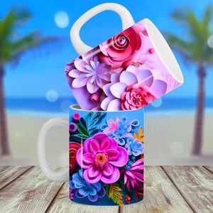K&ouml;nnte beinhalten: Zwei wei&szlig;e Keramikbecher mit Blumendesigns. Der obere Becher hat rosa, wei&szlig;e und lila Blumen. Der untere Becher hat blaue, rosa und gr&uuml;ne Blumen.