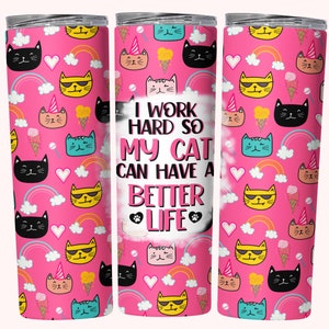 May include: Pink tumbler with a cat and rainbow pattern. The text on the tumbler reads "I work hard so my cat can have a better life."