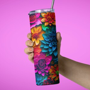 May include: A stainless steel tumbler with a colorful floral design. The tumbler has a lid and a straw. The flowers are in shades of pink, blue, yellow, orange, and green.