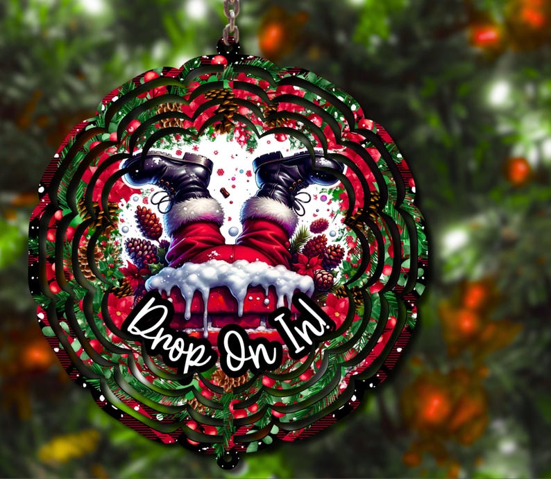 May include: A red and green Christmas wind spinner with a Santa Claus design. Santa is upside down with his legs sticking out of a chimney. The text "Drop On In!" is written on the spinner.