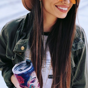 Latina woman holding a  tumbler with a  wrap digital design sublimation png.  a beautiful Latina Chicana Chola woman with colorful tattoos in a vintage car.  Latinx Chola tumbler wrap.