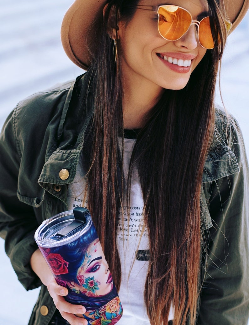 Latina woman holding a  tumbler with a  wrap digital design sublimation png.  a beautiful Latina Chicana Chola woman with colorful tattoos in a vintage car.  Latinx Chola tumbler wrap.