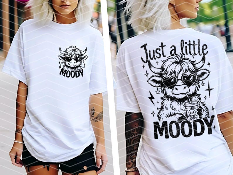 May include: White t-shirt with a black and white graphic of a cow wearing sunglasses and holding a drink. The text "Just a little MOODY" is printed on the shirt.