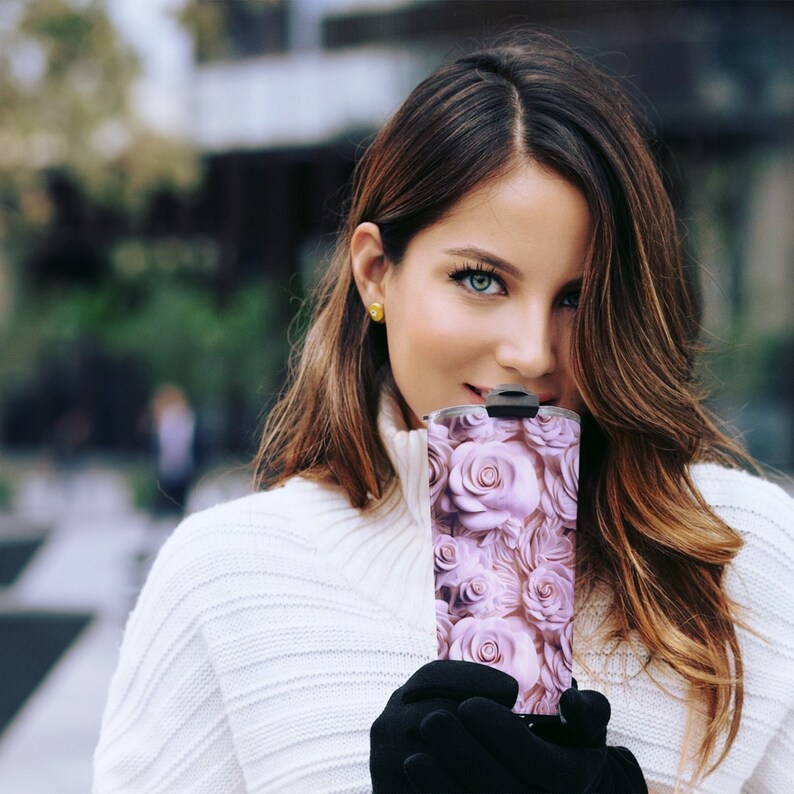 woman holding a pretty floral tumbler with a  wrap digital design sublimation png.  a 3d design featuring pink roses in a carved effect.  roses floral 3d carved effect tumbler wrap