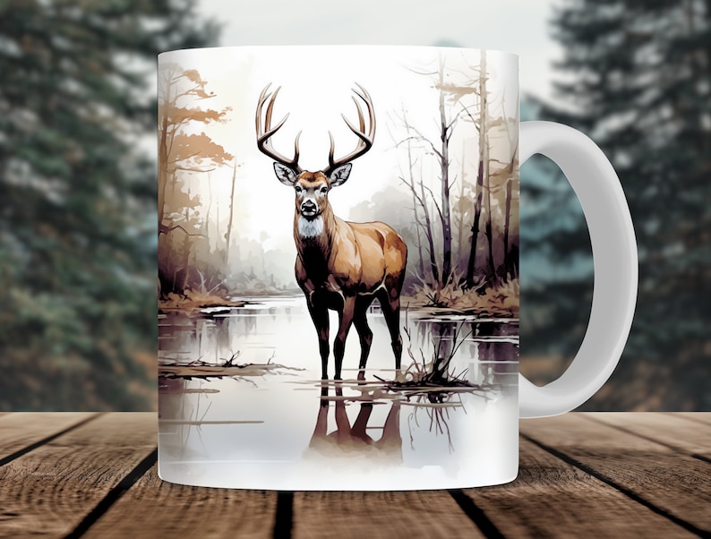 May include: White ceramic mug with a brown deer standing in a lake with a forest background. The deer has large antlers and is looking directly at the viewer.