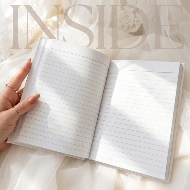 May include: An open notebook with white pages featuring horizontal black lines for writing. The word INSIDE is printed in large, light-colored capital letters across the top of the open pages, which are illuminated by soft, natural light.