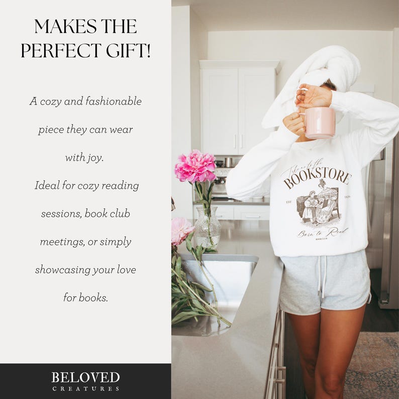 May include: White sweatshirt with a graphic print of a bookstore with the text "To the Bookstore, Born to Read". The model is wearing the sweatshirt with white shorts and a white towel on her head.