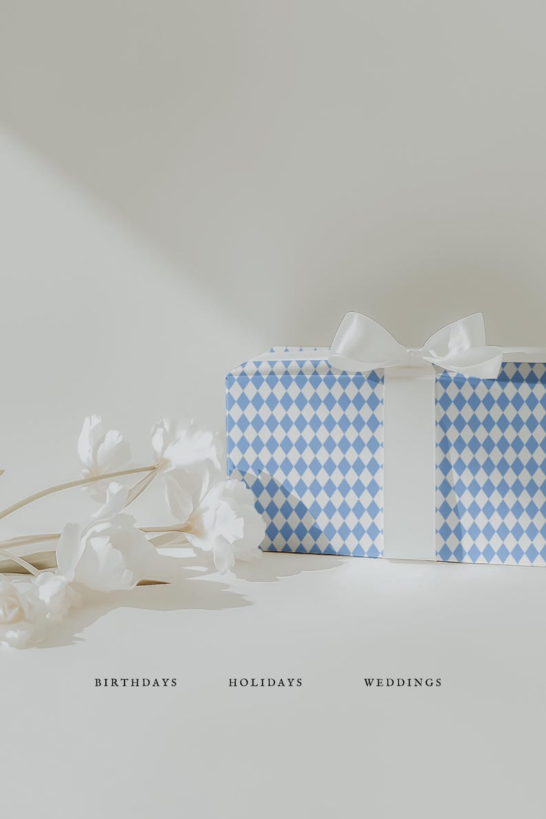May include: A gift box wrapped in blue and white diamond patterned paper, tied with a white satin ribbon. White flowers are arranged to the left of the box. The words "BIRTHDAYS", "HOLIDAYS", and "WEDDINGS" are below the box.