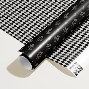 May include: A roll of black wrapping paper with a floral pattern and a roll of white paper with a black and white checkered pattern. The black paper has a silver floral design. The white paper has a QR code.