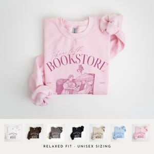 May include: Pink sweatshirt with the text "Take me to the Bookstore" in a pink script font. The sweatshirt features a vintage illustration of two women reading a book. The text "EST 1829" is printed below the illustration.