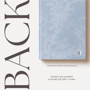 May include: A blue journal cover with a white tree pattern. The text "Journal cover is printed no metallic foil, fabric or leather" is printed on the bottom of the image.