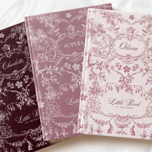 May include: Three hardcover journals titled Little Book of Thoughts, featuring intricate floral and woodland patterns. The covers are deep burgundy, mauve, and pale pink, personalized with the names Charlotte, Sophia, and Olivia in script.