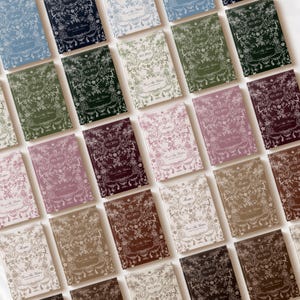 May include: A collection of recipe journals in various colors, including blue, green, pink, and brown. Each journal features a floral design and the word "Recipes" on the cover. The phrase "From My Kitchen" is also visible.