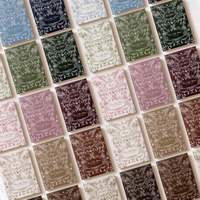 May include: A collection of recipe journals in various colors, including blue, green, pink, and brown. Each journal features a floral design and the word "Recipes" on the cover. The phrase "From My Kitchen" is also visible.