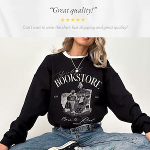 May include: Black sweatshirt with a white graphic print of a bookstore with the text "The Notable Bookstore Est 1829" and "Born to Read Bookclub".