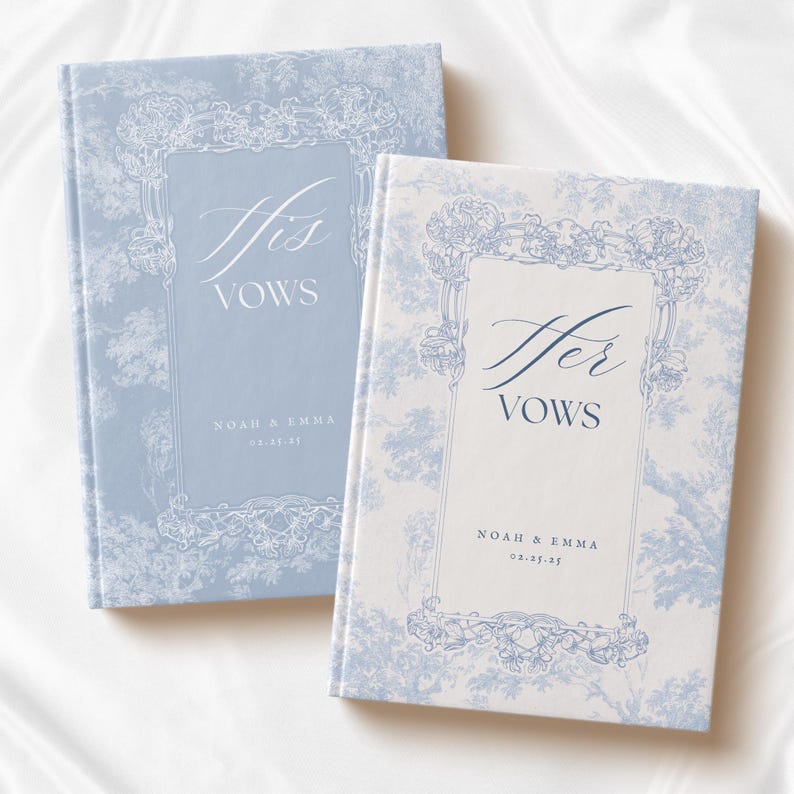 May include: Two blue and white patterned vow books with the text "His Vows" and "Her Vows" on the front covers. The books are for Noah & Emma and the date 02.23.25.