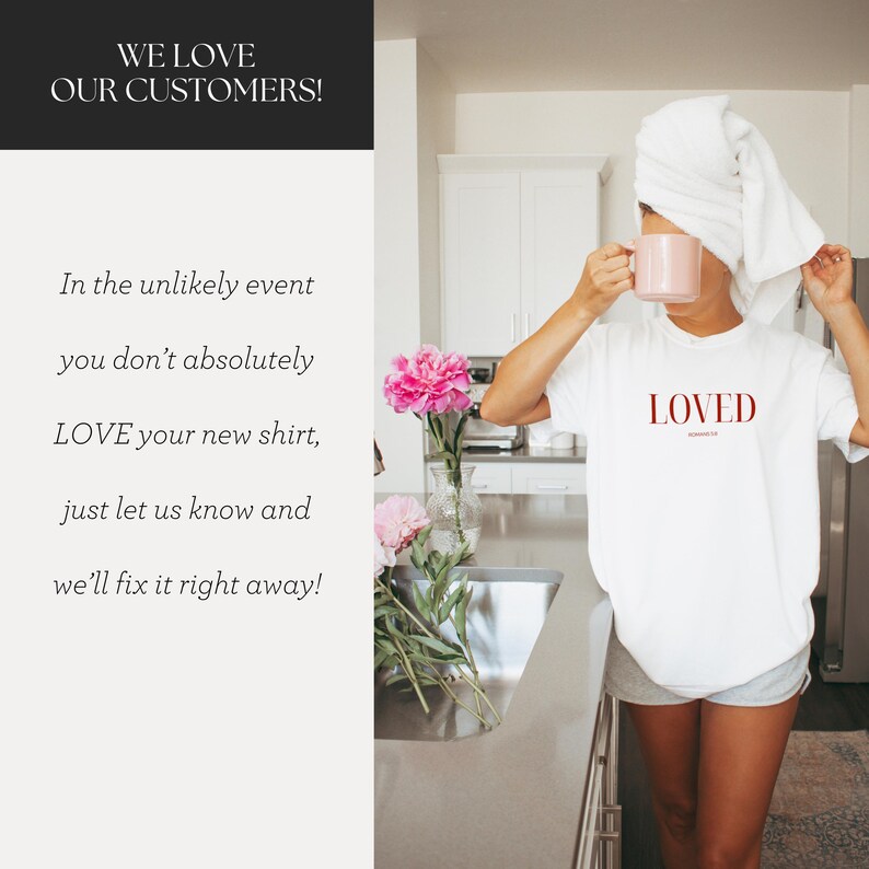 May include: A white t-shirt with the word "LOVED" printed in red on the front. The shirt is being worn by a person in a kitchen setting.