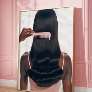 May include: A framed mirror displays a person with long, dark hair being combed with a pink comb. The person is wearing a pink top. The background features a pink wall with molding and a wooden floor.