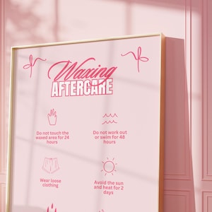 May include: Pink poster with a gold frame and the text "Waxing Aftercare" with a list of instructions for aftercare, including avoiding touching the waxed area for 24 hours, avoiding working out or swimming for 48 hours, wearing loose clothing, avoiding the sun and heat for 2 days, avoiding hot baths, showers, and saunas, and avoiding shaving the area.