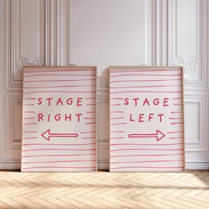 May include: Two framed art prints with the text "STAGE RIGHT" and "STAGE LEFT" in pink, with arrows indicating direction. The background is white with pink horizontal lines. The frames are a light wood color.