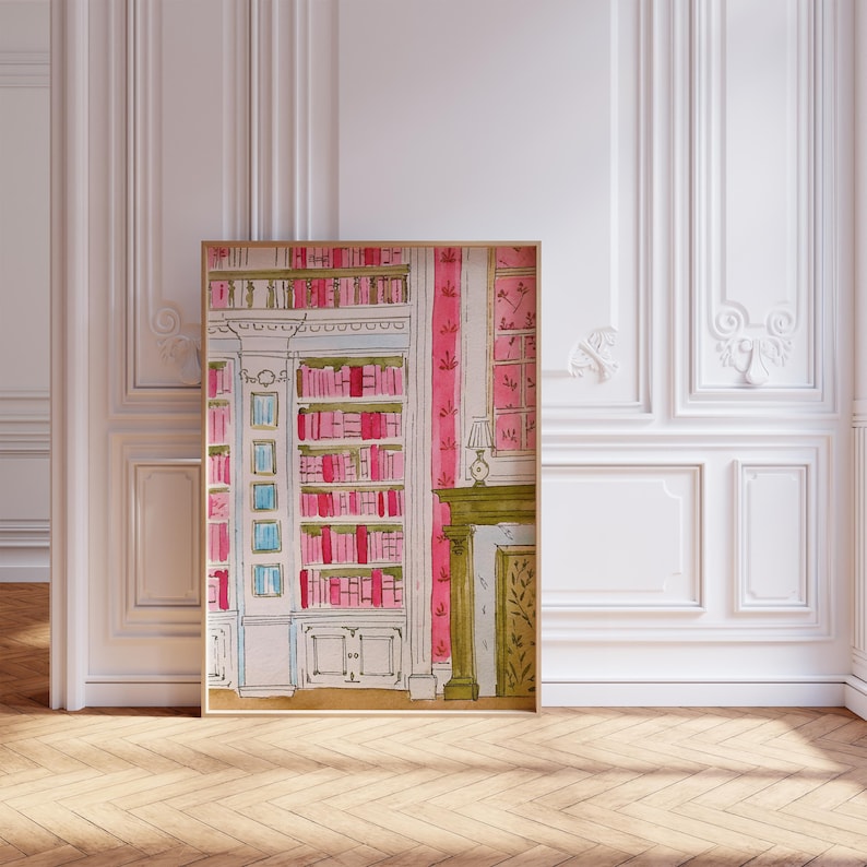 May include: Watercolor painting of a library interior with a bookshelf filled with pink and red books. The painting also features a fireplace, a lamp, and pink striped wallpaper. The artwork is framed in a light brown frame.