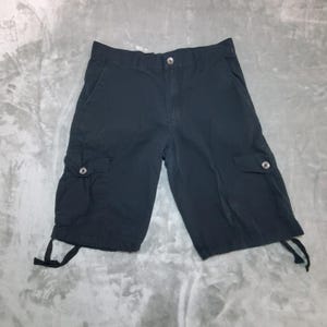 May include: A set of three ceramic mugs with a speckled, matte finish. The mugs are in shades of cream, light gray, and dark gray. Each mug has a simple, modern design and a rounded handle.