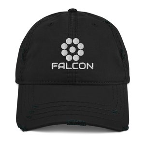 May include: Black distressed baseball cap with white embroidered logo and text "FALCON". The logo is a circular design of seven white dots. The cap has a curved peak and adjustable strap.