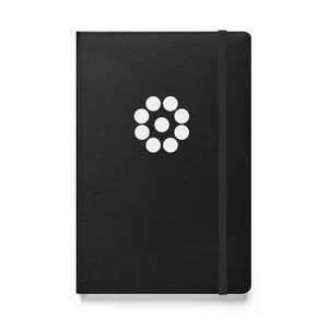 May include: Black leather-bound journal with a white circular logo featuring a series of smaller circles.