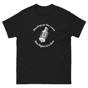 May include: Black t-shirt with a white graphic of a 3D printer nozzle and the text "Heating up the scene one layer at a time."