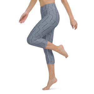 May include: A pair of blue and white patterned capri leggings with a geometric design.