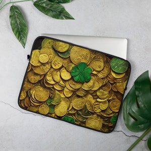 May include: A laptop sleeve with a design of a pile of gold coins and a green four-leaf clover.