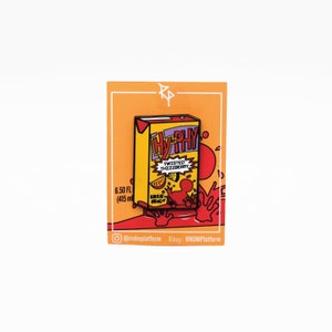 May include: A yellow and red enamel pin of a juice box with the text "Hy-Phy" and "Twisted Thizzberry". The juice box is surrounded by red splatter and the text "6.50 FL (415 ml)".