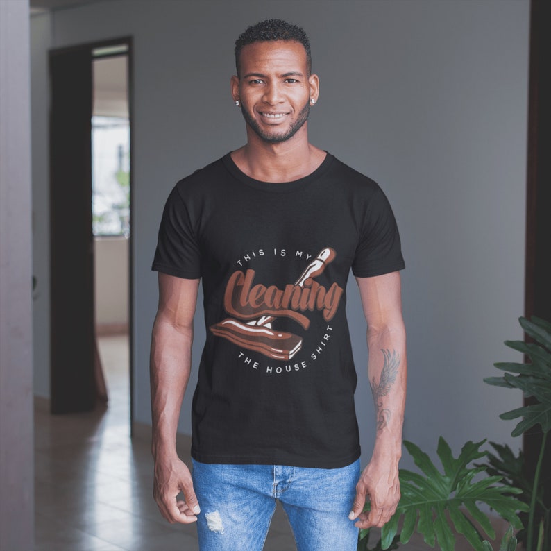 May include: A black t-shirt with a brown graphic of a cleaning tool and the text "This is my cleaning the house shirt".