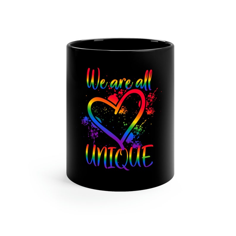 May include: Black coffee mug with a rainbow heart and the text "We are all UNIQUE".