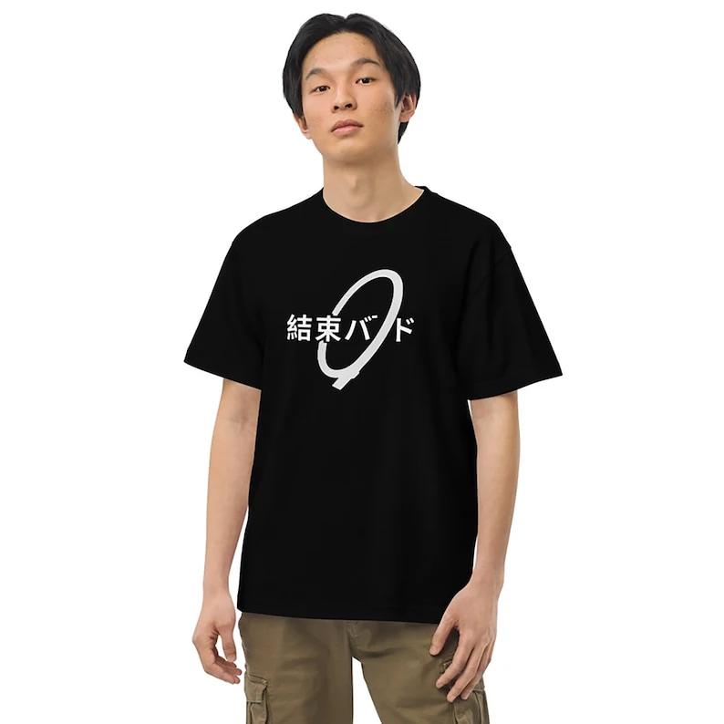May include: A black t-shirt with a white graphic design. The graphic features a circle with a line through it and the text "結東バ" in Japanese.
