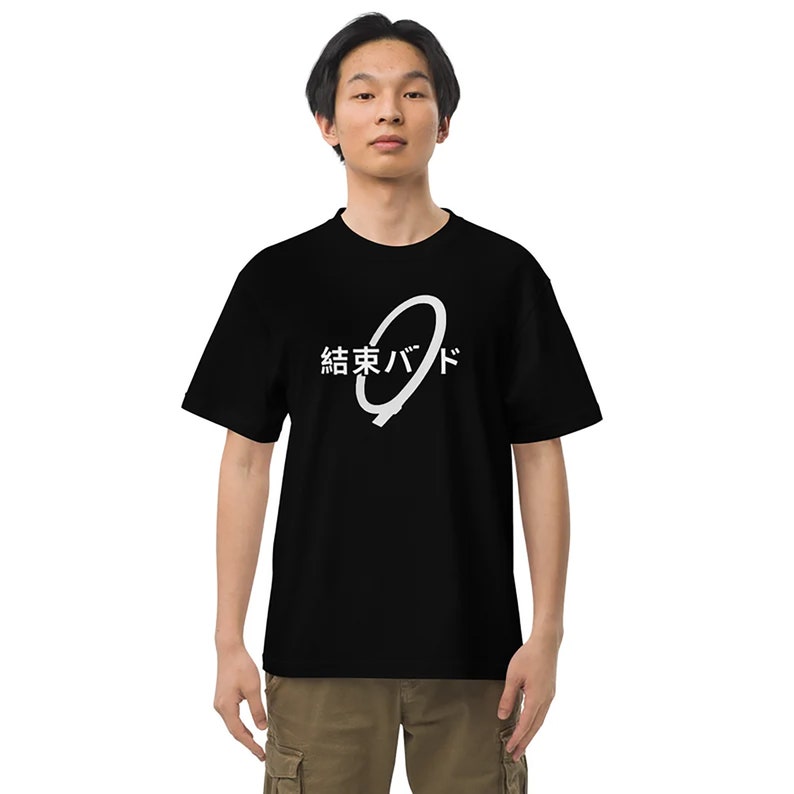 May include: A black t-shirt with a white graphic design. The graphic features a white circle with a line through it and the text "結東バッド" in Japanese.